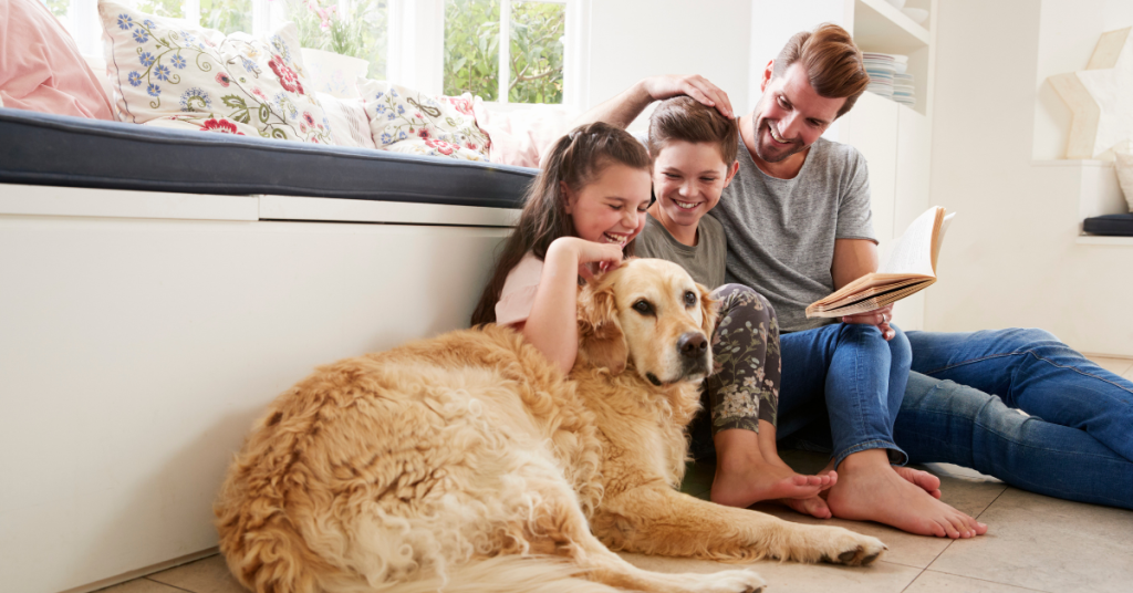 happy family and pet dog in home